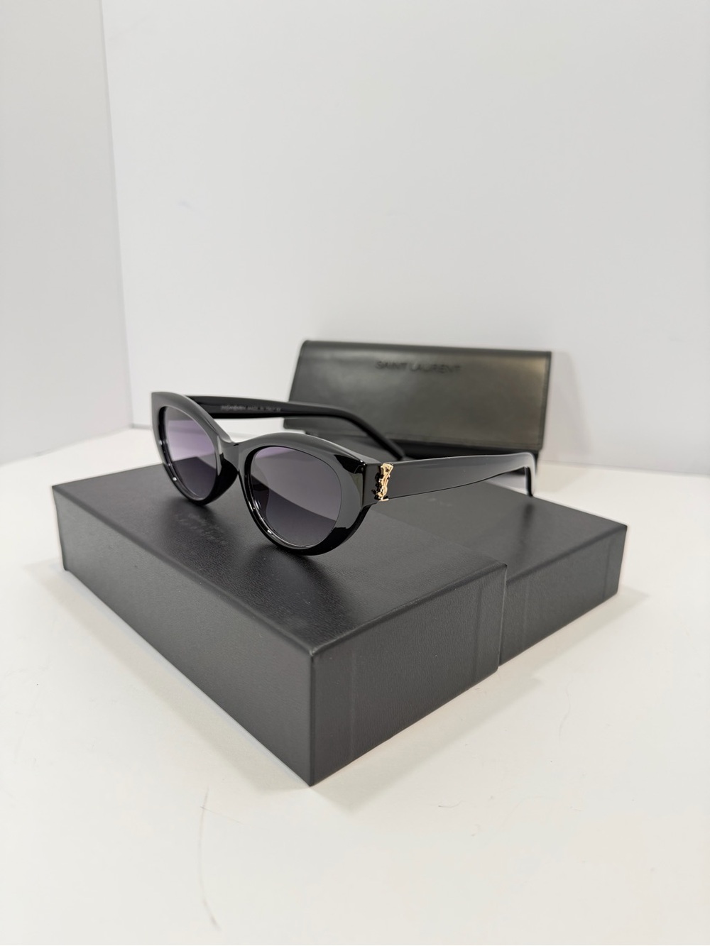Saint Laurent Glossy Black Rounded Cat-Eye Sunglasses with Gold Accent